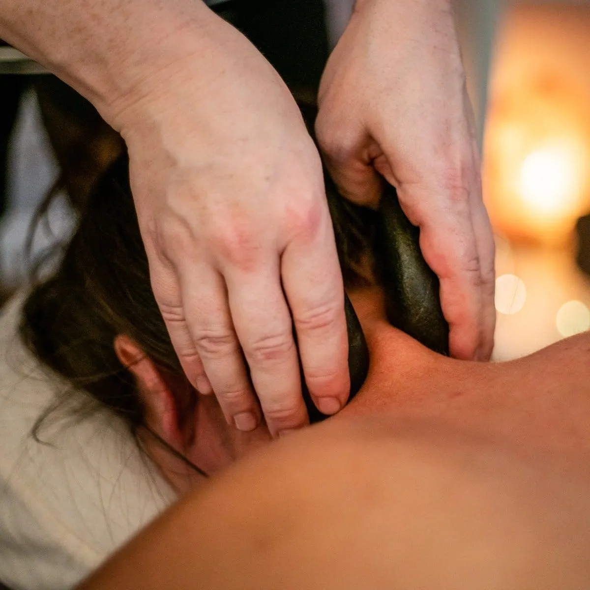 A Focus 4 Massage therapist working tension out of a client's neck and shoulders